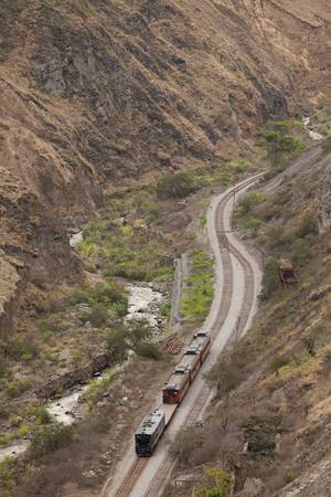 Touristic train passing by Alausi city in Ecuadorian Andesの写真素材