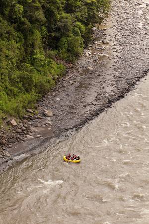 A group of men and women, with a guide, white water rafting on the Patate river, Ecuadorの写真素材