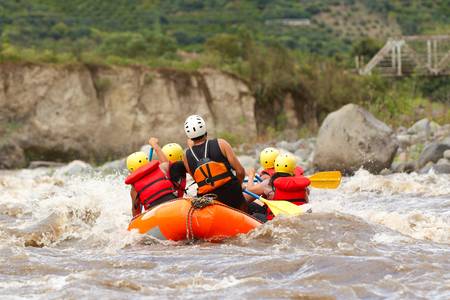 A group of men and women, with a guide, white water rafting on the Patate river, Ecuadorの写真素材