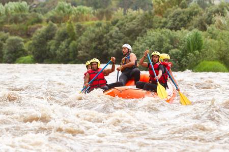 A group of men and women, with a guide, white water rafting on the Patate river, Ecuadorの写真素材