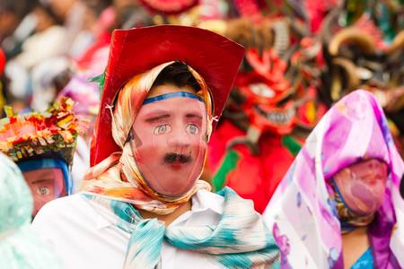 Pillaro,Ecuador - January 6, 2012: Childrens desguised as adults marching on the streets of Pillaro, Ecuador during the Diablada festivities on January 6, 2012のeditorial素材