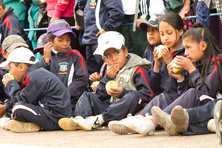 Pillaro,Ecuador - January 6, Pillaro,Ecuador - January 6, 2012: Young boys waiting on the streets of Pillaro for the masked devils to pass during the Diablada de Pillaro, very important ceremony in Ecuador.のeditorial素材
