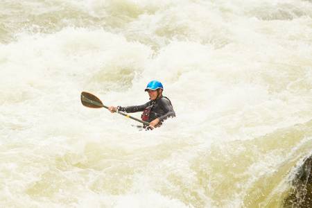 an active kayaker on the rough waterの写真素材