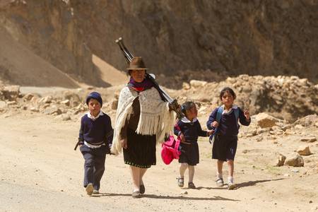 Salasaca,Ecuador - October 1,2012: Mother with childrens comming back from school are forced to walk miles due to the lack of public transportation in the area.のeditorial素材