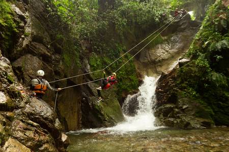 improvized zipline during a canyoning tour in ecuadorian rainforestの写真素材