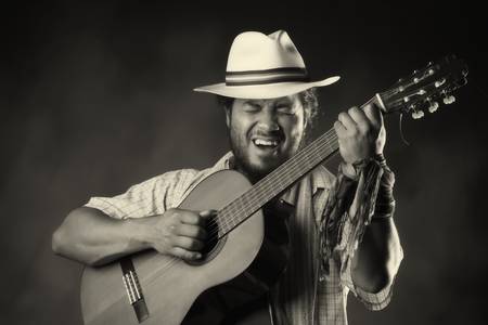 Rastafarian man playing classic guitarの写真素材