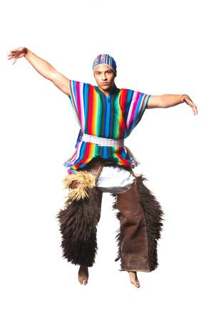 ecuadorian dancer dressed up in traditional clothing from the andes performing a jump. llama or alpaca pants. studio shot isolated on white.の写真素材