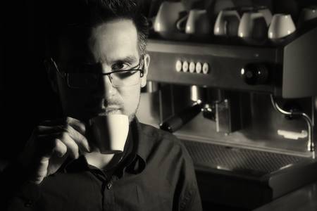 coffee sommelier tasting espresso cup, high contrast monochrome image