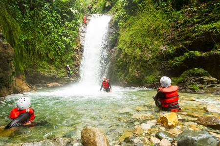 Couple of tourist admiring the natural beauty of a waterfall, canyoning trip.の写真素材