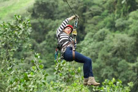 adult woman on zip line, ecuadorian andes