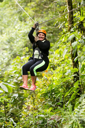 oversized adult woman on zip line trip, nearby banos de agua santa, ecuador