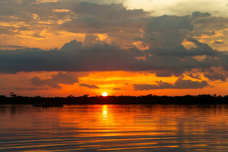 Orange sky on lagoon Grande, Cuyabeno National Park Ecuador, polarized medium shot on sunsetの写真素材