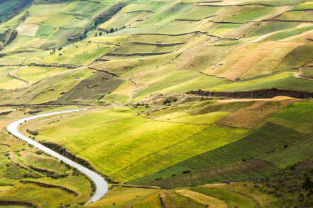 High altitude road in Ecuador crossing agricultural landscape