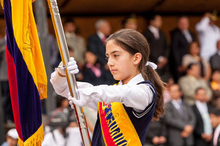 Banos De Agua Santa, Ecuador - 26 July 2015: Young School Girl Holding With Pride The National Flag Of Ecuador For The Summer Break Festivity In Banos De Agua Santa On July 26, 2015のeditorial素材