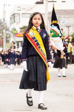Banos De Agua Santa, Ecuador - 26 July 2015: First In Class Young Girl Leading Her Group For The Summer Break Festivity In Banos De Agua Santa On July 26, 2015のeditorial素材