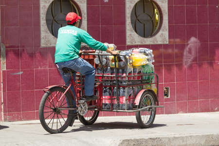 Ambato, Ecuador - 24 January 2014: Coca Cola Products Being Delivered By Bicycle Style Carts Common Practice In Ambato On January 24, 2014のeditorial素材