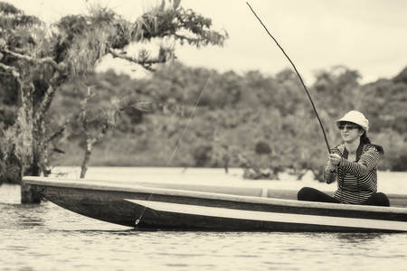 Woman Fishing Piranha In Cuyabeno National Park Ecuadorの写真素材