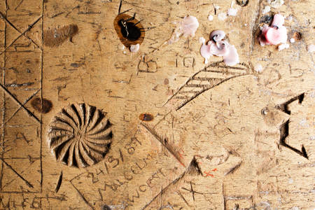 Tourists Marks On A Old Wooden Tableの写真素材