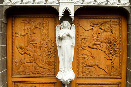wood carved entrance of an medieval built churchの写真素材