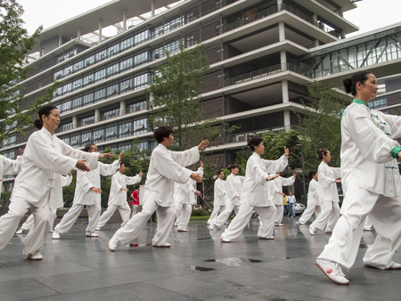 CHENGDU, CHINA - JUNE 4, 2012: Unidentified people practicing tai chi on the street of Chengdu, China. In China, tai chi  is categorized under the Wudang grouping of Chinese martial arts,  applied with internal power.のeditorial素材