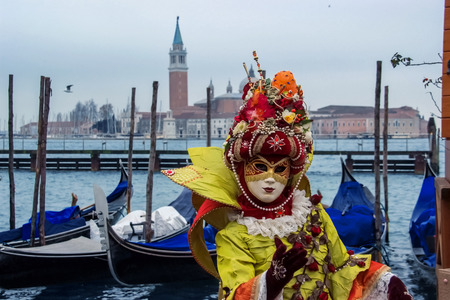 VENICE, ITALY - FEBRUARY 5, 2008: Unidentified person with Venetian carnival mask in Venice, Italy. At 2008 it is held from January 26th to February 5th.の写真素材