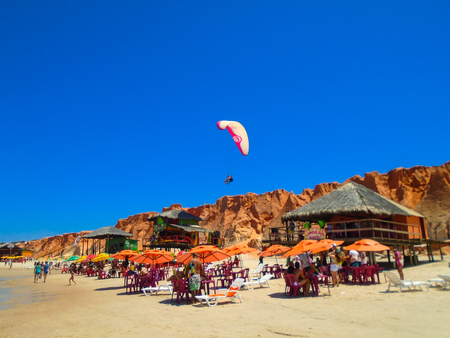 FORTALEZA, BRAZIL - OCTOBER 12, 2015: Unidentified people and paragliders at the Canoa Quebrada Beach. It was a Swiss pilot who introduced this new practice: Gerome Bertand Saunier, best known as Jeronimoのeditorial素材