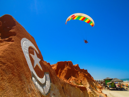 FORTALEZA, BRAZIL - OCTOBER 12, 2015: Unidentified people and paragliders at the Canoa Quebrada Beach. It was a Swiss pilot who introduced this new practice: Gerome Bertand Saunier, best known as Jeronimoのeditorial素材