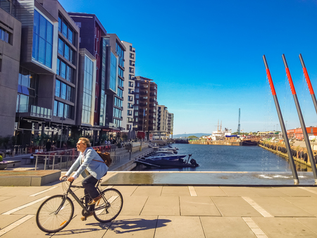 OSLO, NORWAY - MAY 28, 2014: Unidentified people at  Tjuvholmen in Oslo, Norway. This former shipyard  is part of the Fjord City urban renewal program.のeditorial素材