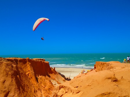 FORTALEZA, BRAZIL - OCTOBER 12, 2015: Unidentified people and paragliders at the Canoa Quebrada Beach. It was a Swiss pilot who introduced this new practice: Gerome Bertand Saunier, best known as Jeronimoのeditorial素材