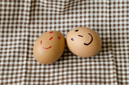 smile love egg couple in brown kitchen towel on wood table