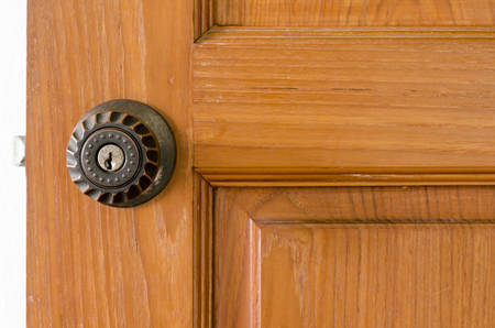 door knob and key hold on wood