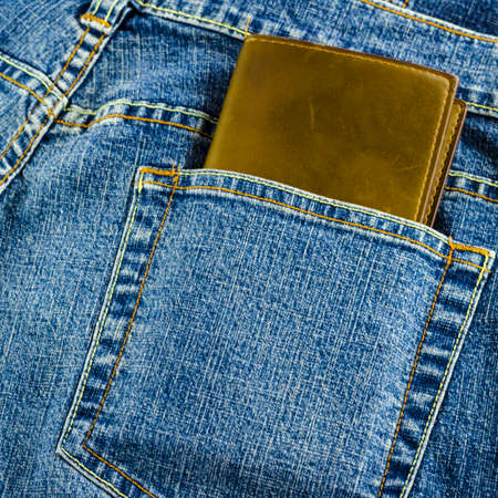 blue jeans pocket with brown walletの写真素材