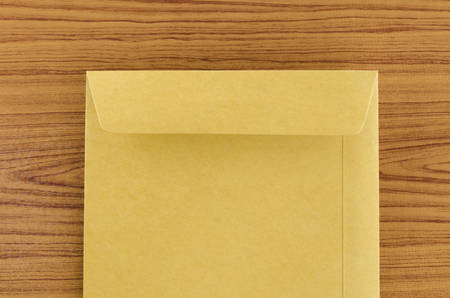 brown envelope on wood table backgroundの写真素材