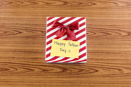 gift box with card write happy father day on wood backgroundの写真素材