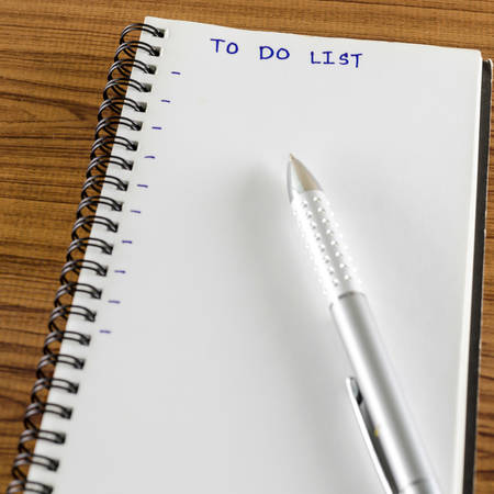 notebook and pen with word to do list on wood background