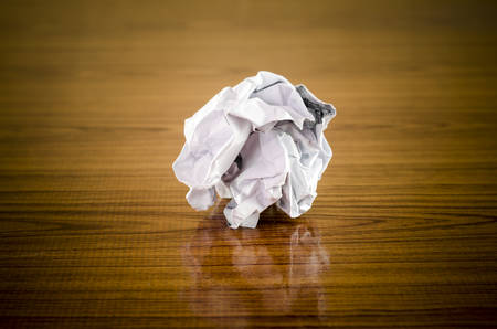 crumpled paper on wood backgroundの写真素材