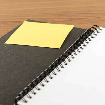 open notebook with post it on wood background