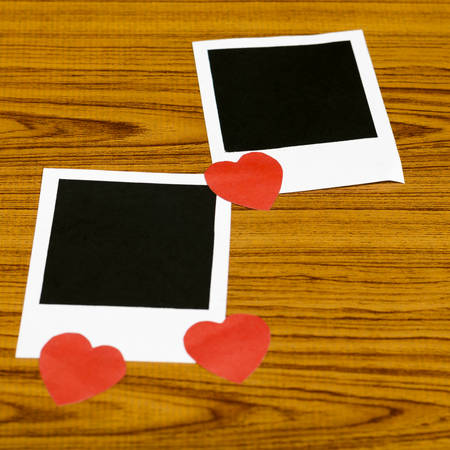 photo frame with heart on wood backgroundの写真素材