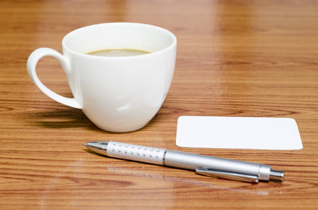 coffee cup and business card on wood backgroundの写真素材