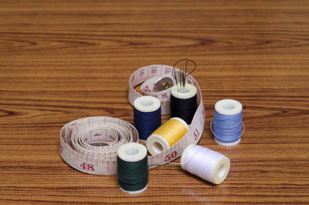sewing kit on wood background