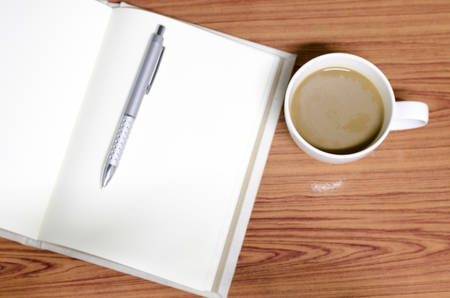 coffee and notebook on wood background concept coffee timeの写真素材