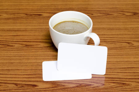 coffee cup and business card on wood backgroundの写真素材