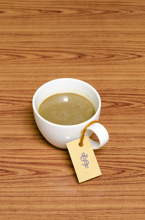 coffee cup with price tag on wood backgroundの写真素材