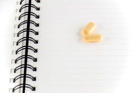 two pills on notebook concept seriousness