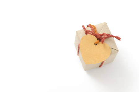heart tag with single craft cardboard gift box on a white backgroundの写真素材