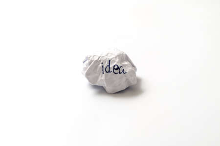 white crumpled paper ball focus idea word on a white backgroundの写真素材