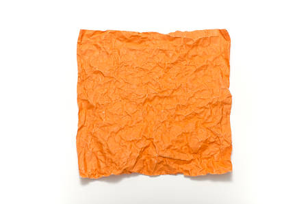 orange crumpled paper texture on a white backgroundの写真素材