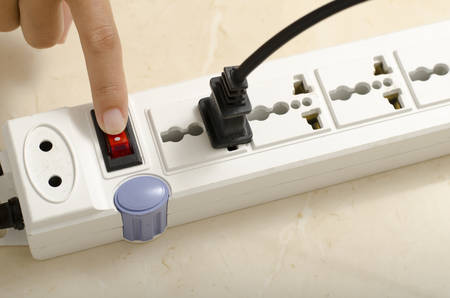 asia woman hand turn on switch multiple  socket plug electric