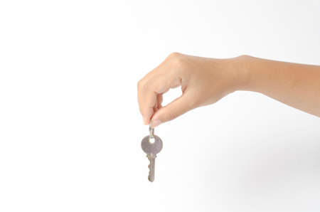 asia woman right hand holding key on a white backgroundの写真素材