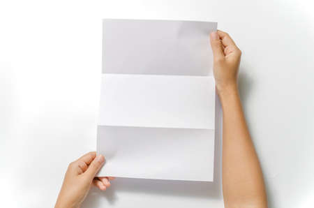 woman two hands holding blank paper a4 size on a white backgroundの写真素材